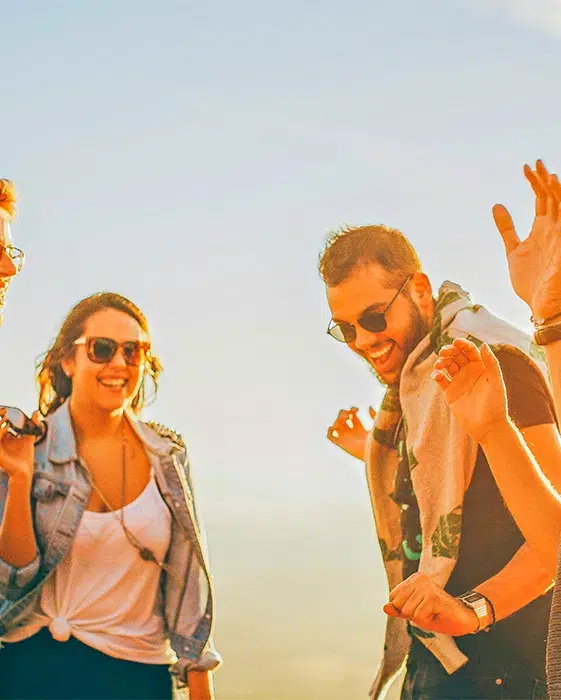 a group of friends enjoying the campsite at sunset