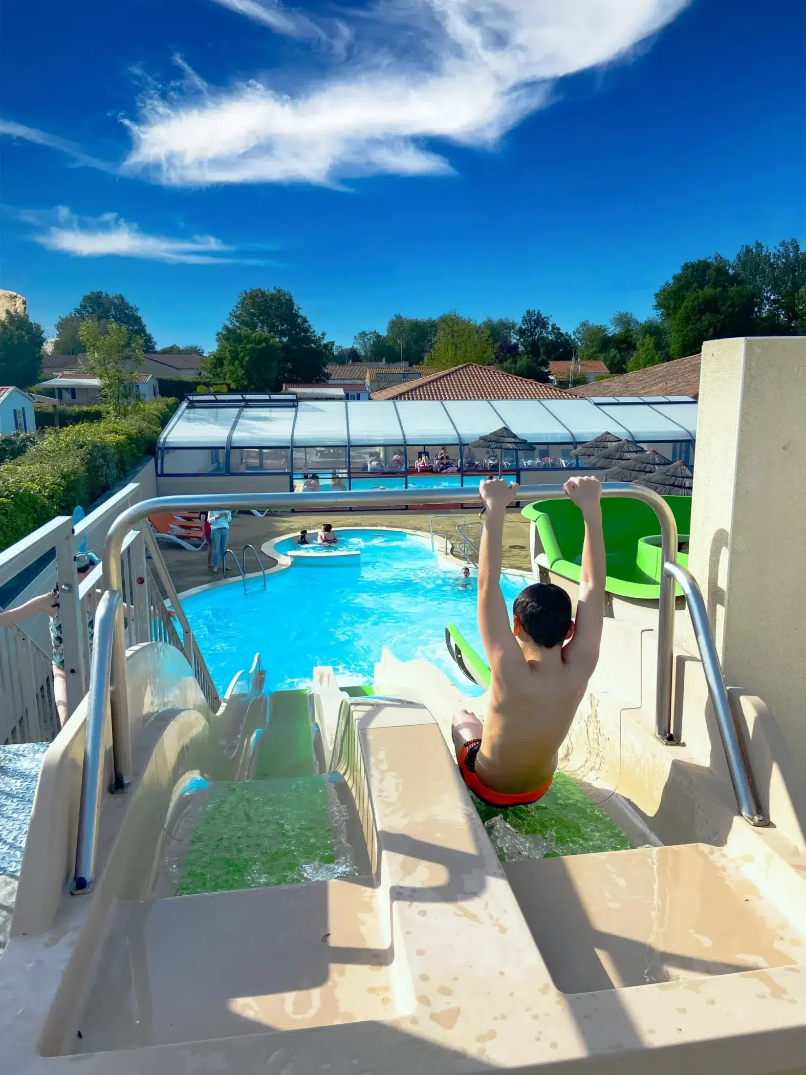 Child on a water slide at the campsite near Puy du Fou in Vendée